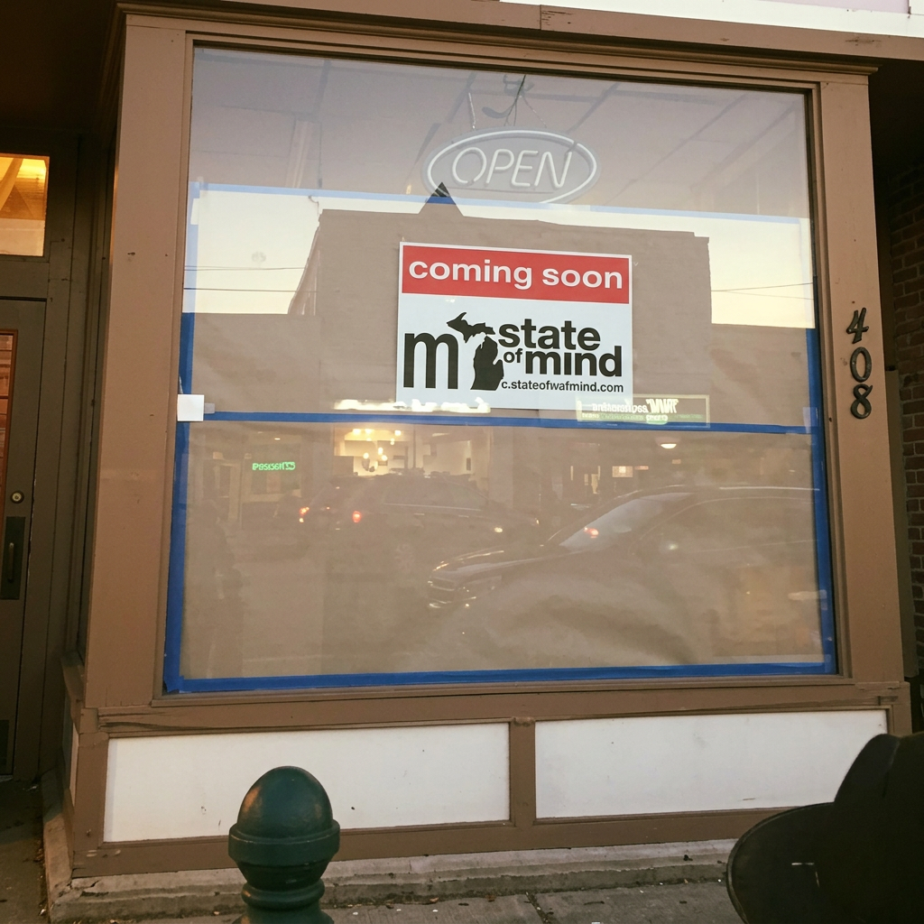 408 S Main storefront on day one — 'Coming Soon' sign in the window
