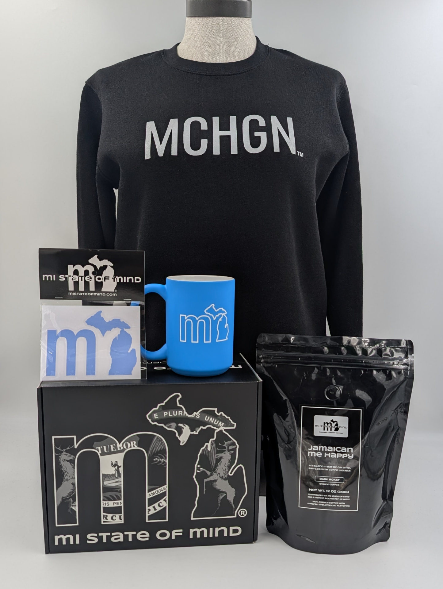 Black MCHGN crewneck packed in a Michigander Box with coffee, a Megawatt Mug and a mi sticker